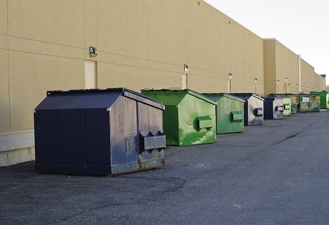 construction dumpsters on a worksite surrounded by caution tape in Fayette, NY